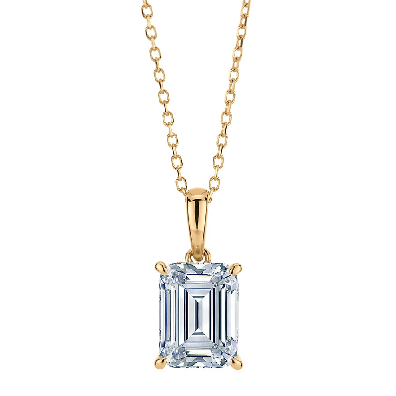 Emerald Cut and Round Brilliant solitaire pendant with 1.81 carats* of diamond simulants in 10 carat yellow gold